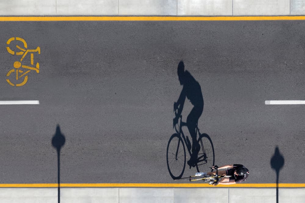 Overhead Cyclist Shadow by Renee Doyle — canvas wall art