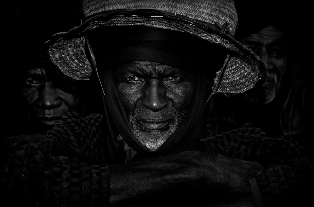 African Elder Intense Gaze by Joxe Inazio Kuesta Garmendia — canvas wall art