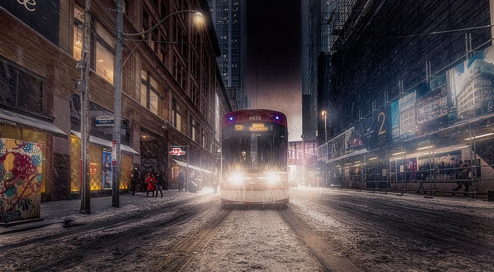 Snowy City Night Tram by Jackson Carvalho — canvas wall art