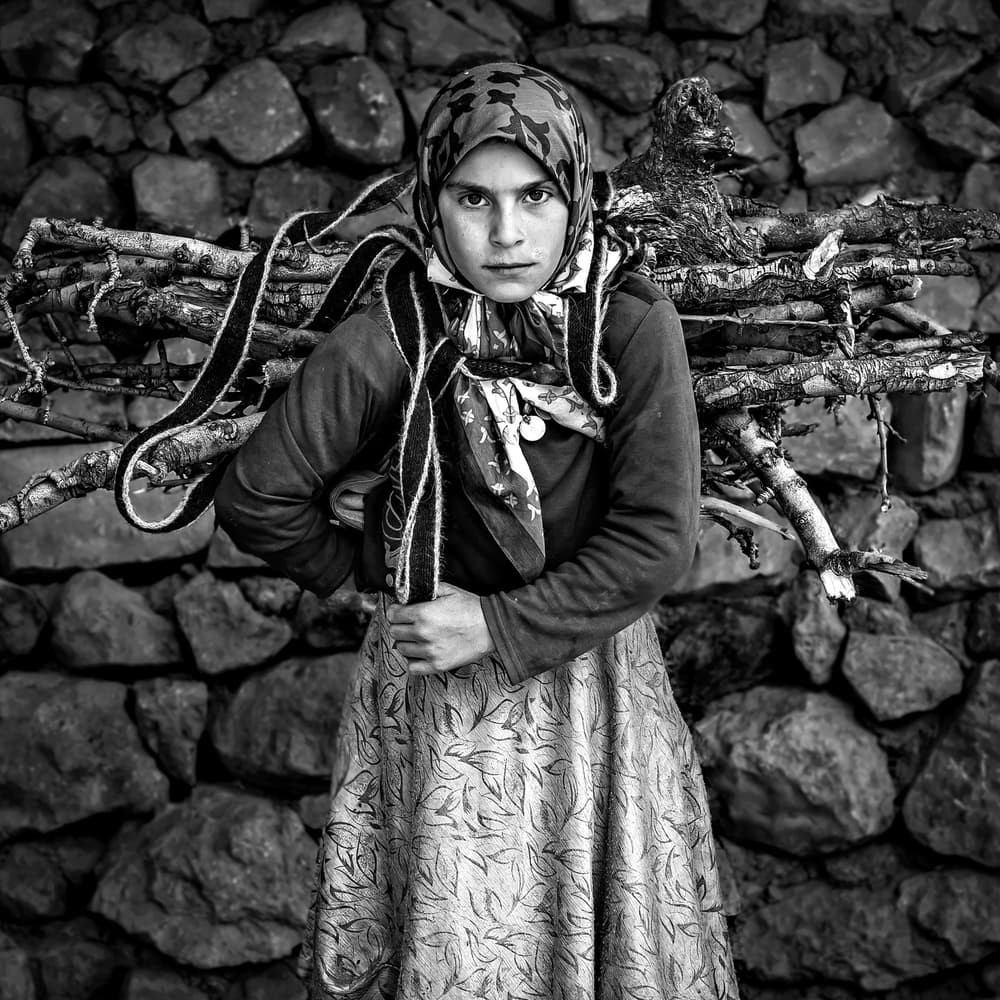 Young Woman Carrying Firewood by Mohammadreza Momeni — canvas wall art