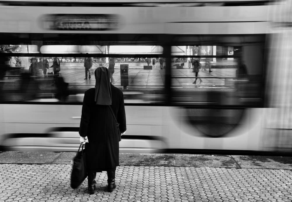 Nun Watches Passing Train by Jani Novak — canvas wall art