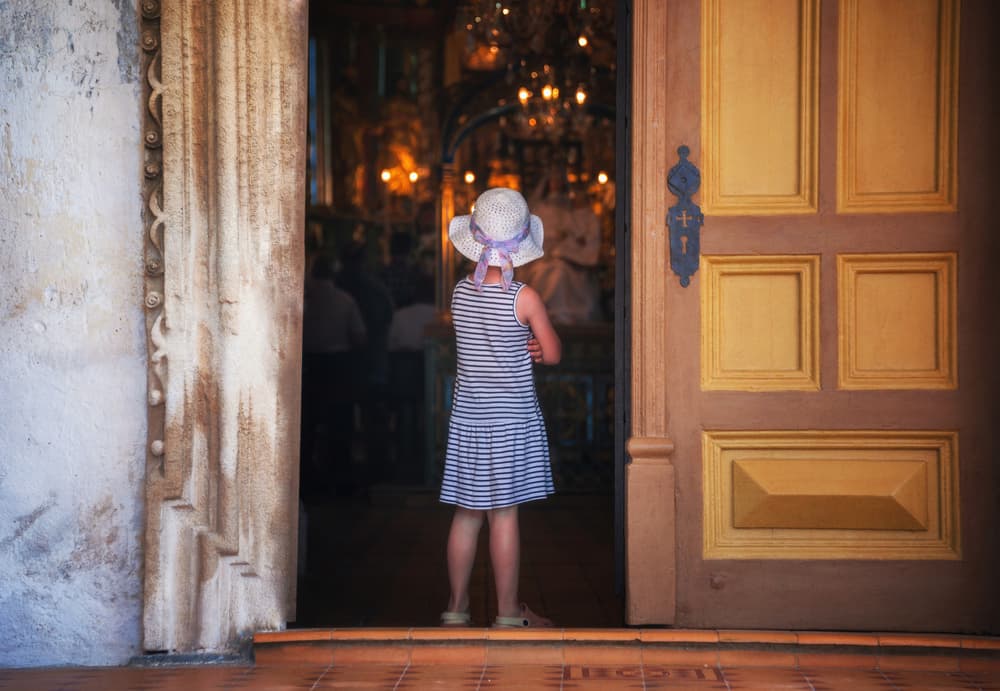 Child Looking Into Church by Ales Krivec — canvas wall art