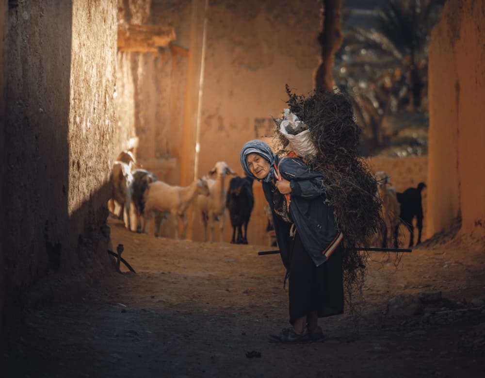 Traditional Woman Carrying Load by wail.Hamdane — canvas wall art