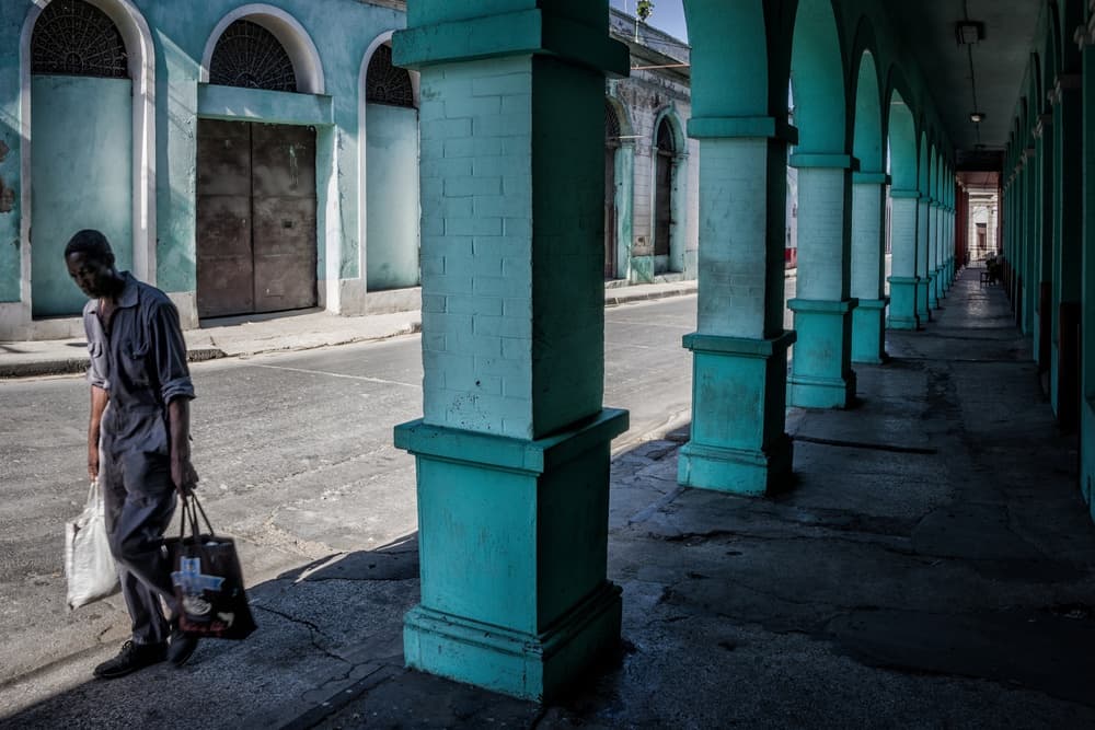 Man Walking Havana Street by Pavol Stranak — canvas wall art