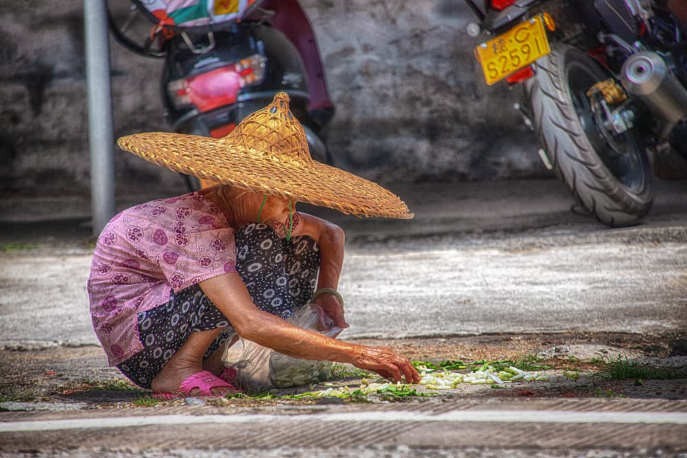 Crouching Woman Straw Hat by Guy Krier — canvas wall art