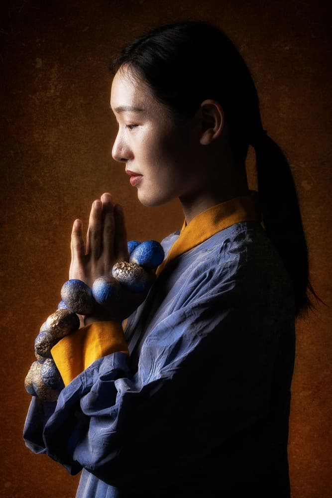 Serene Woman in Prayer by Amnon Eichelberg — canvas wall art
