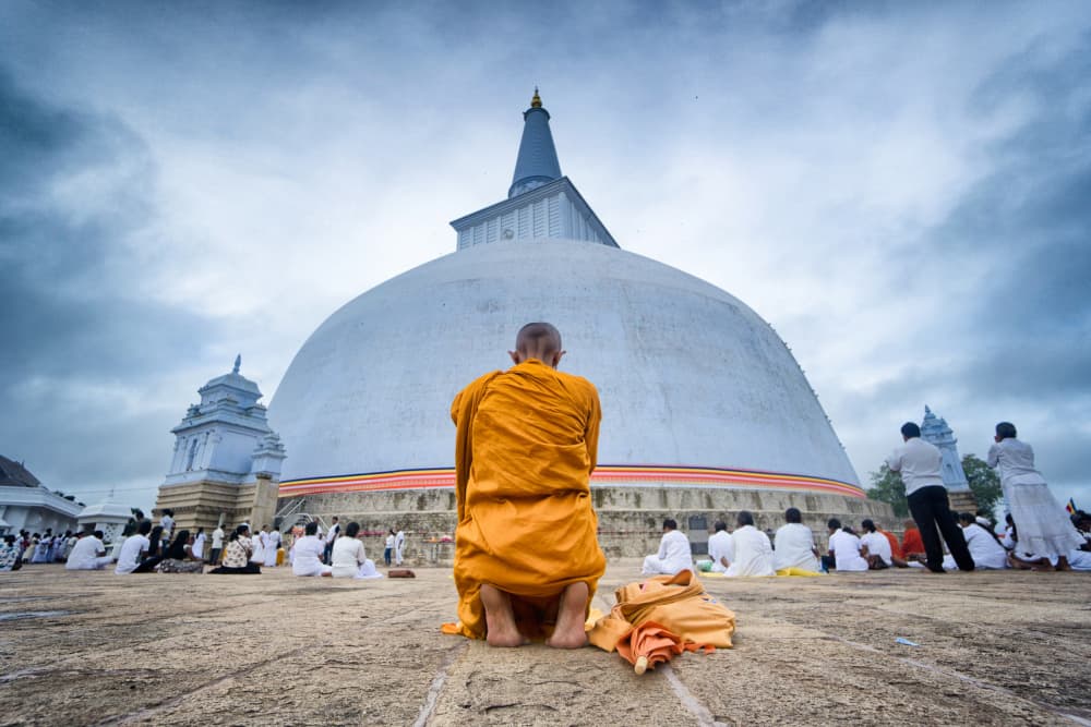 Buddhist Monk at Stupa by Samara Ratnayake — canvas wall art