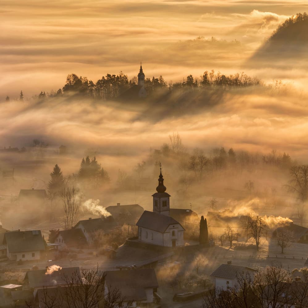 Sunrise Over Foggy Village by Ales Krivec — canvas wall art