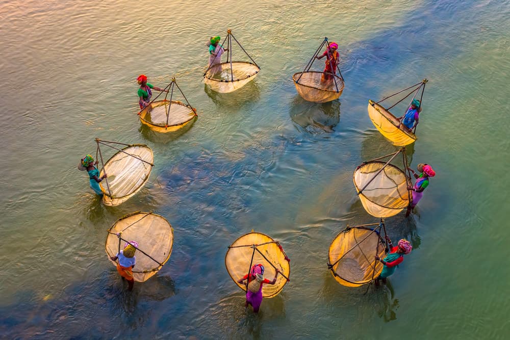 Golden River Fishing Women by Saurabh Sirohiya — canvas wall art