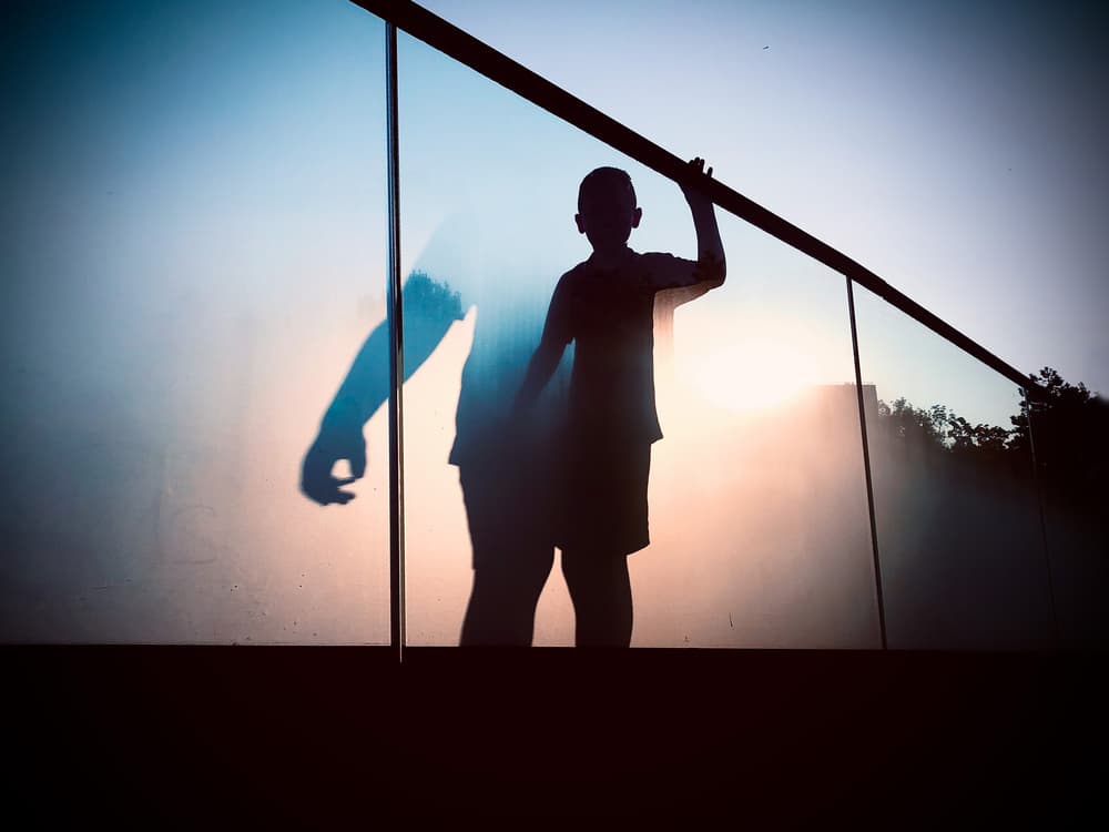 Boy's Sunset Silhouette by Mirela Momanu — canvas wall art