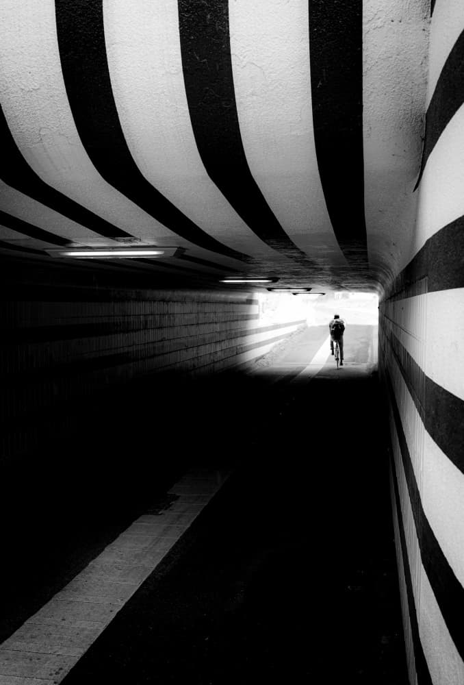 Cyclist in Striped Tunnel by Andreas Timar — canvas wall art