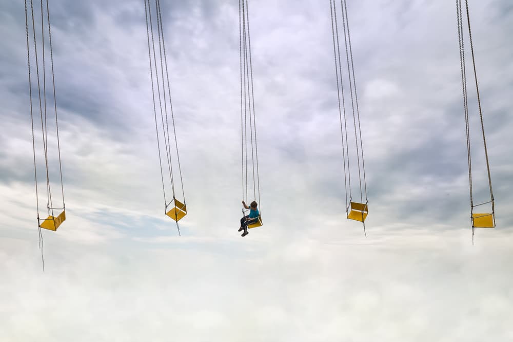 Swinging Through Clouds by Marius Cinteza — canvas wall art