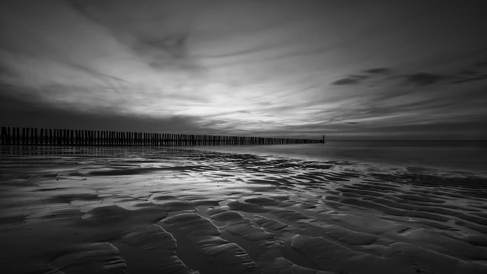 Dramatic Coastal Groynes by Dominic Schroeyers — canvas wall art