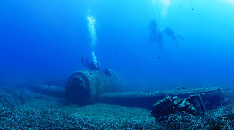 Divers Explore Sunken Plane by nini_filippini — canvas wall art