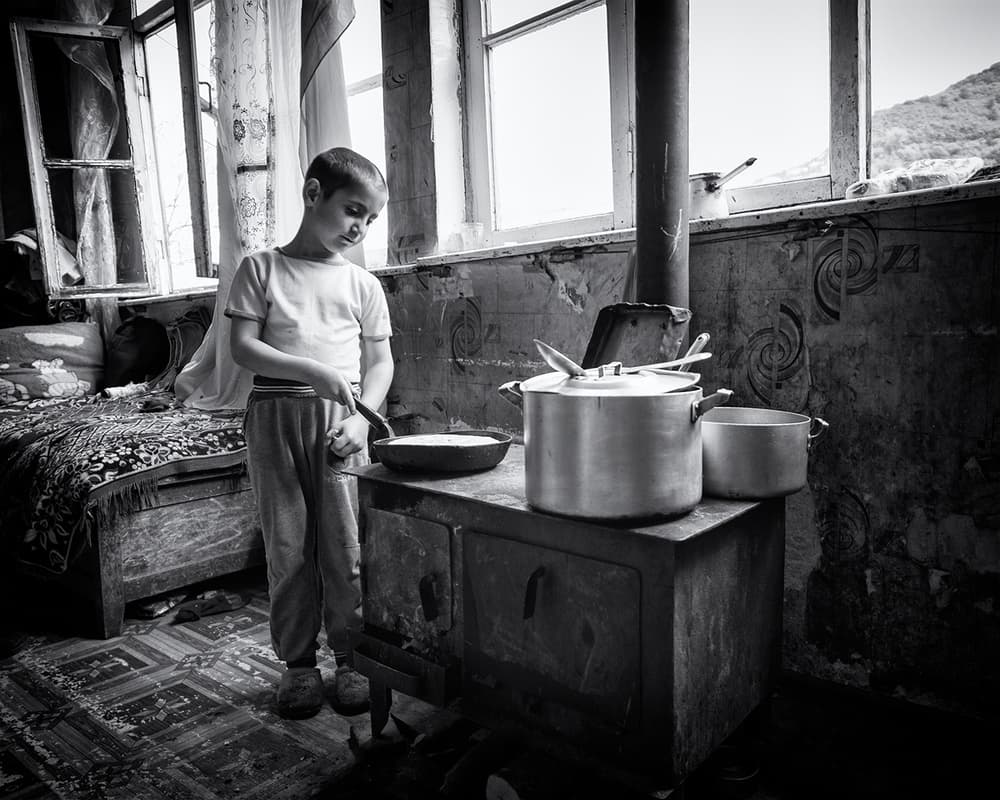 Boy Cooking by Window Light by Marcel Rebro — canvas wall art