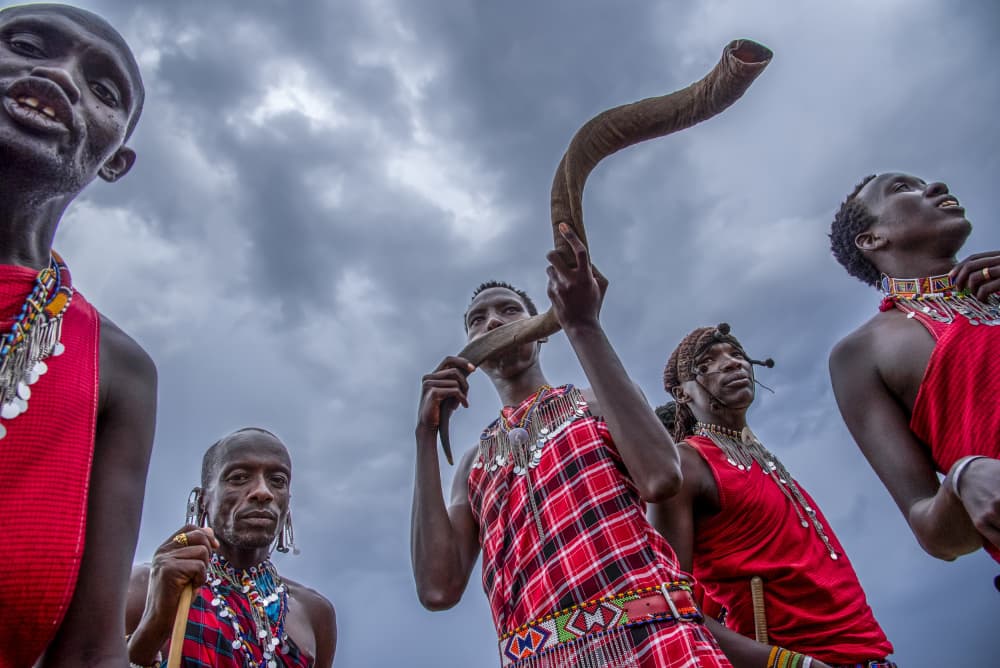 Maasai Men Blowing Horn by Anita Singh — canvas wall art