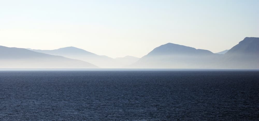 Serene Ocean Mountain Horizon by Leif Westling — canvas wall art