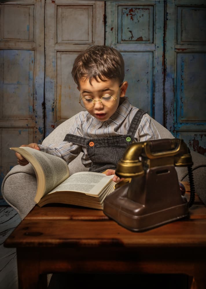 Boy Reading Vintage Phone by Bassant Meligy — canvas wall art