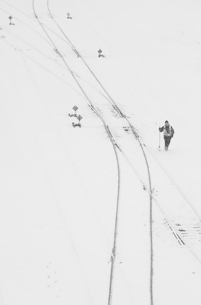 Snowy Railroad Worker by Jian Wang — canvas wall art