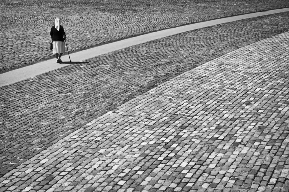 Elderly Walker Cobblestones by Kike Balenzategui — canvas wall art