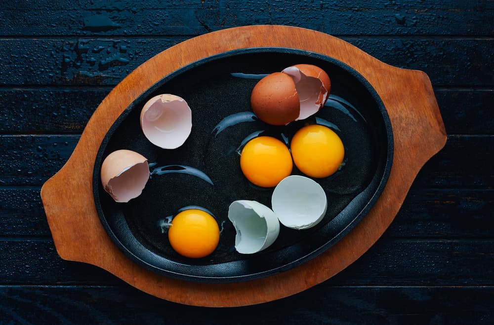Fresh Eggs on Pan by Karina Aleksandrova — canvas wall art