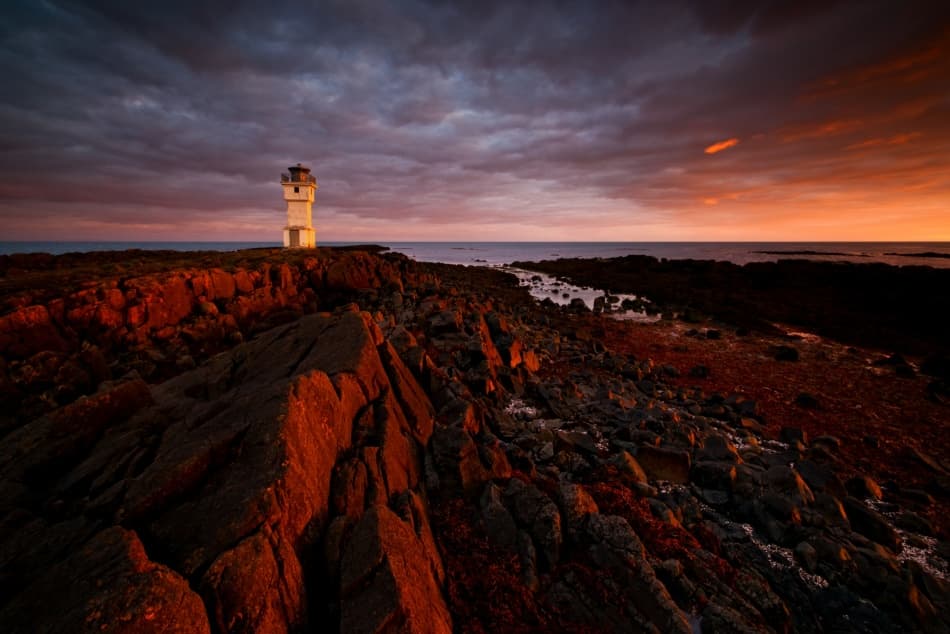 Lighthouse On Fiery Coast by Raymond Hoffmann — canvas wall art