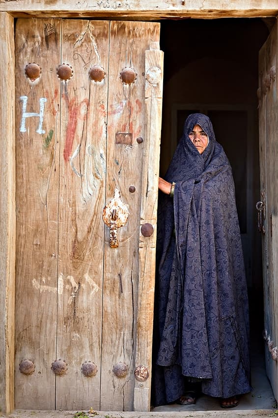 Woman at Rustic Doorway by Mohammadreza Momeni — canvas wall art