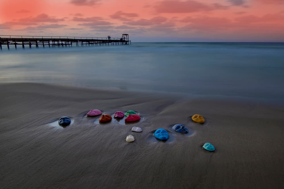 Colorful Rocks at Sunset Pier by Eyal Amer — canvas wall art