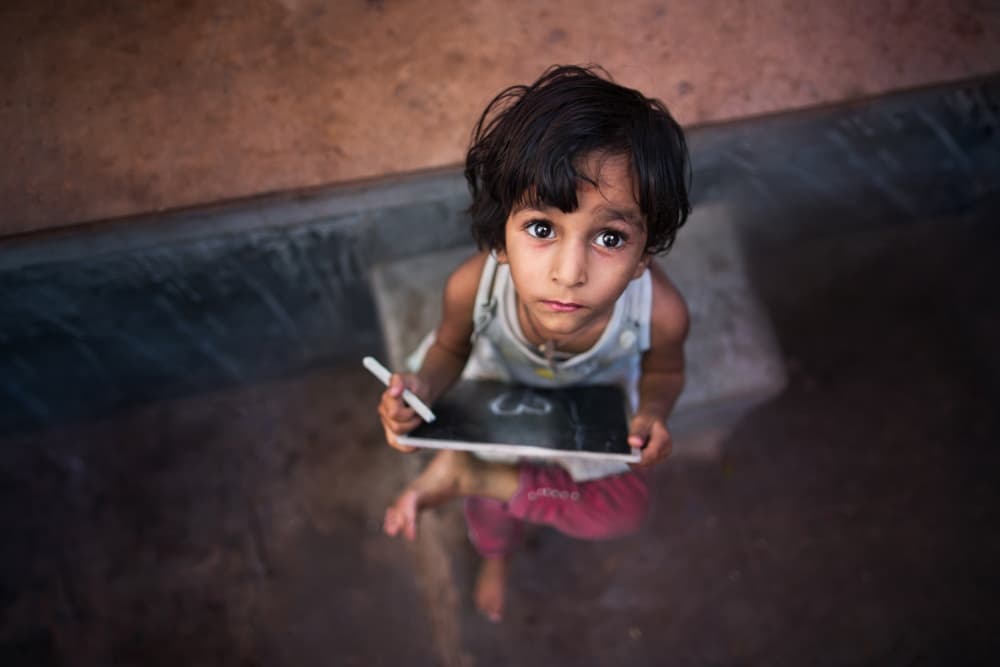 Curious Child with Tablet by Mohammed Baqer — canvas wall art