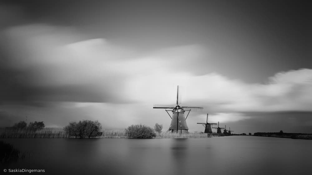 Windmills Under Moving Clouds by Saskia Dingemans — canvas wall art