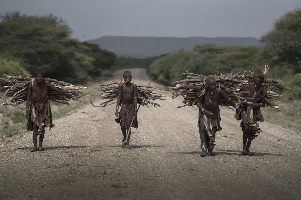 African Women Carrying Wood by Sarawut Intarob — canvas wall art