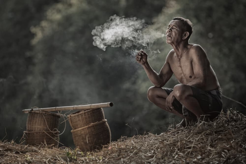 Rural Man Smoking by Jakkree Thampitakkull — canvas wall art