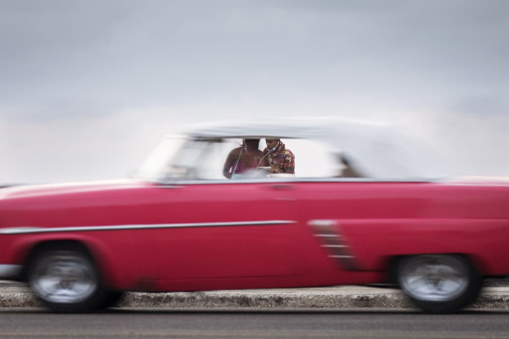 Classic Car Couple Drive by Dan Mirica — canvas wall art