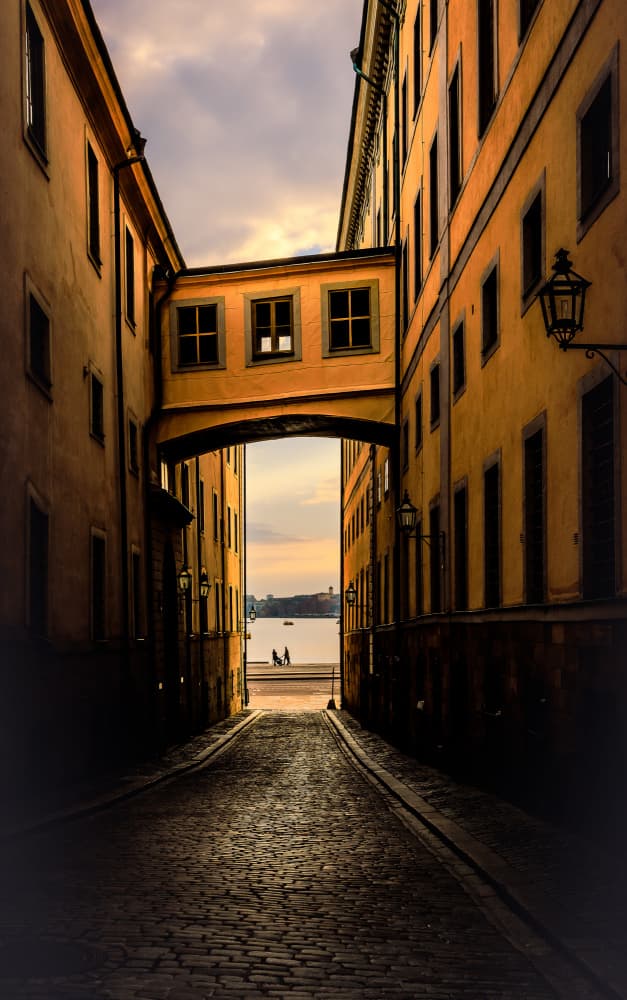 Cobblestone Alley Water View by Stephanie Kleimann — canvas wall art