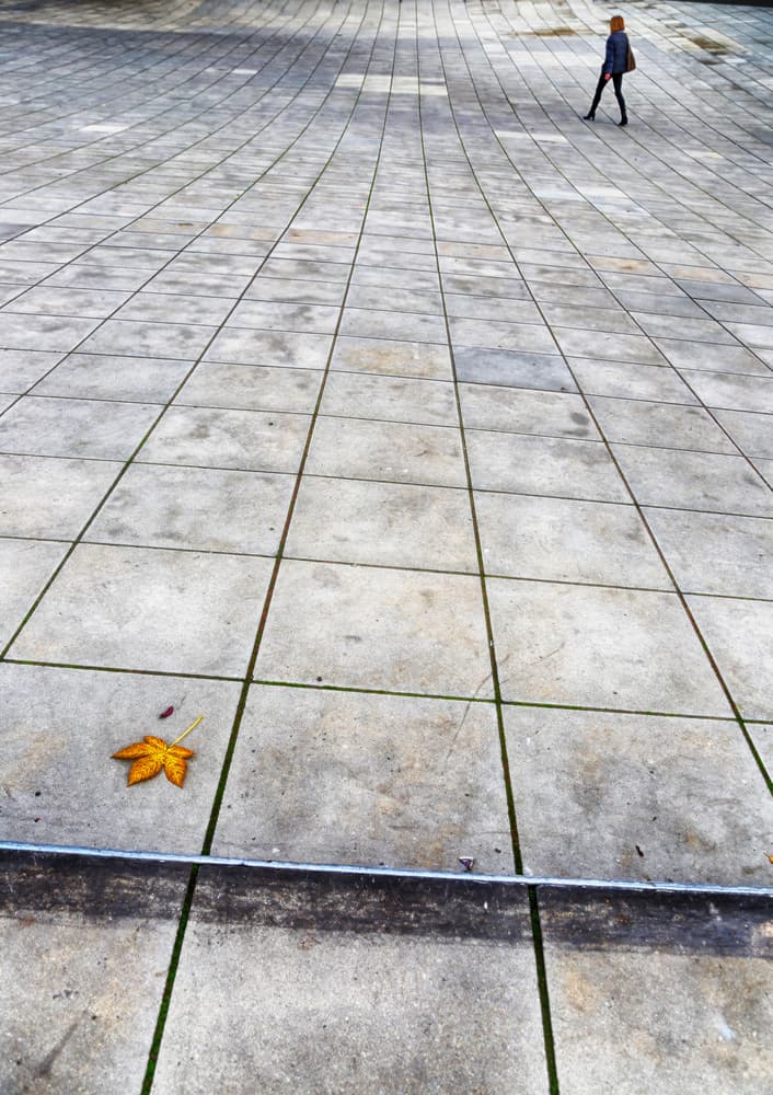 Lone Figure Tiled Plaza by Anna Niemiec — canvas wall art
