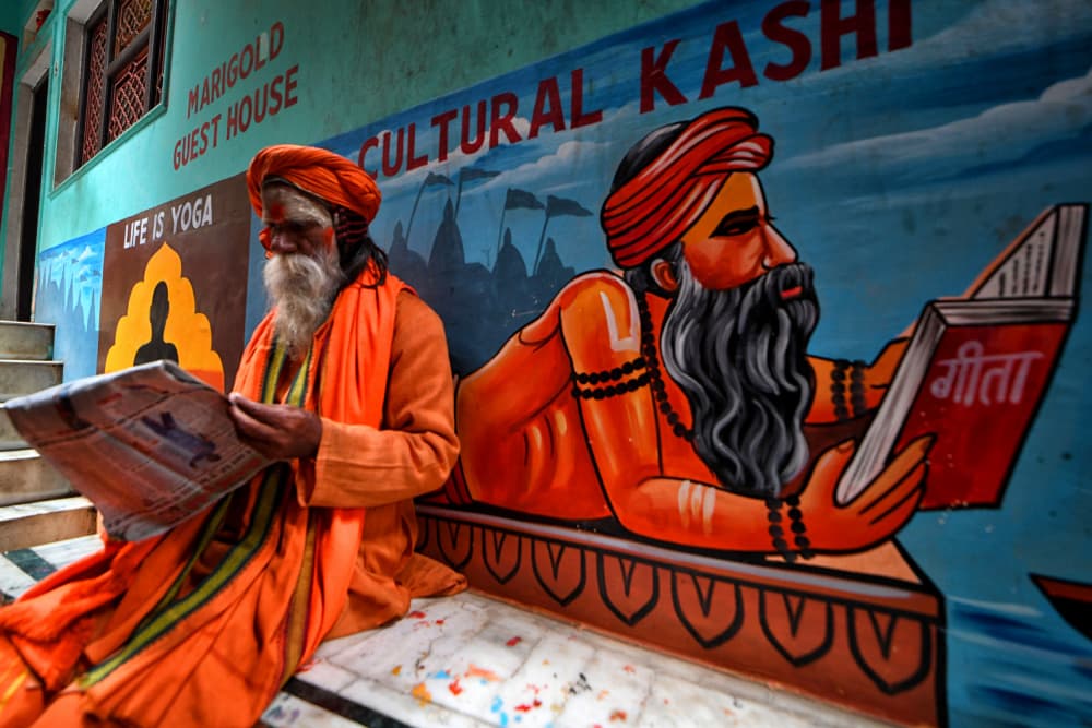 Varanasi Sadhu Reading News by Avishek Das — canvas wall art
