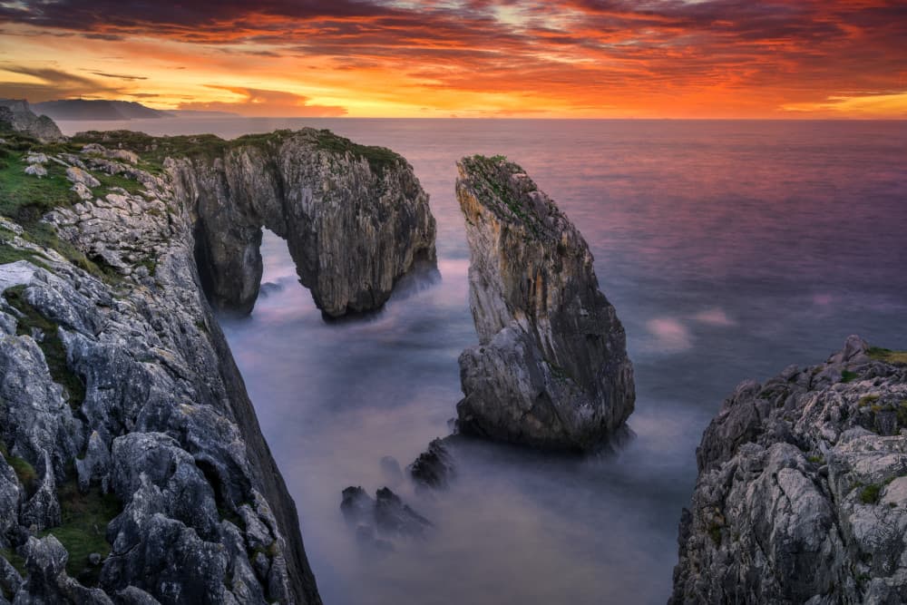 Dramatic Sea Arch Sunset by Juan I. Cuadrado — canvas wall art