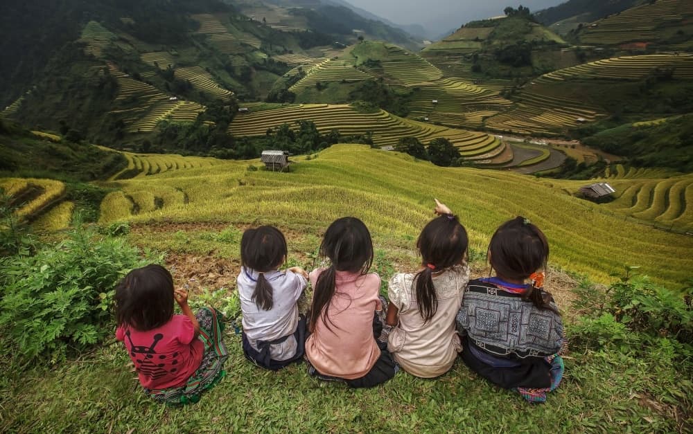 Children Overlooking Terraced Valley by Jakkree Thampitakkull — canvas wall art