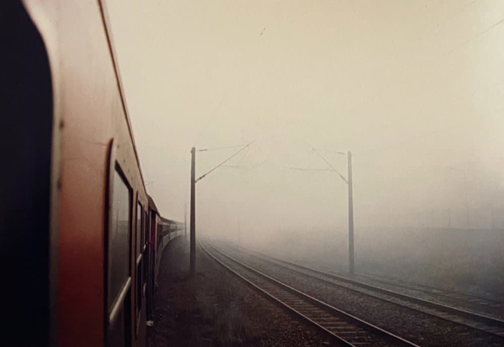Red Train Through Fog by Yalım Vural — canvas wall art