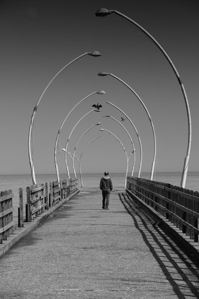 Walking the Arched Pier by Mehmet inal — canvas wall art