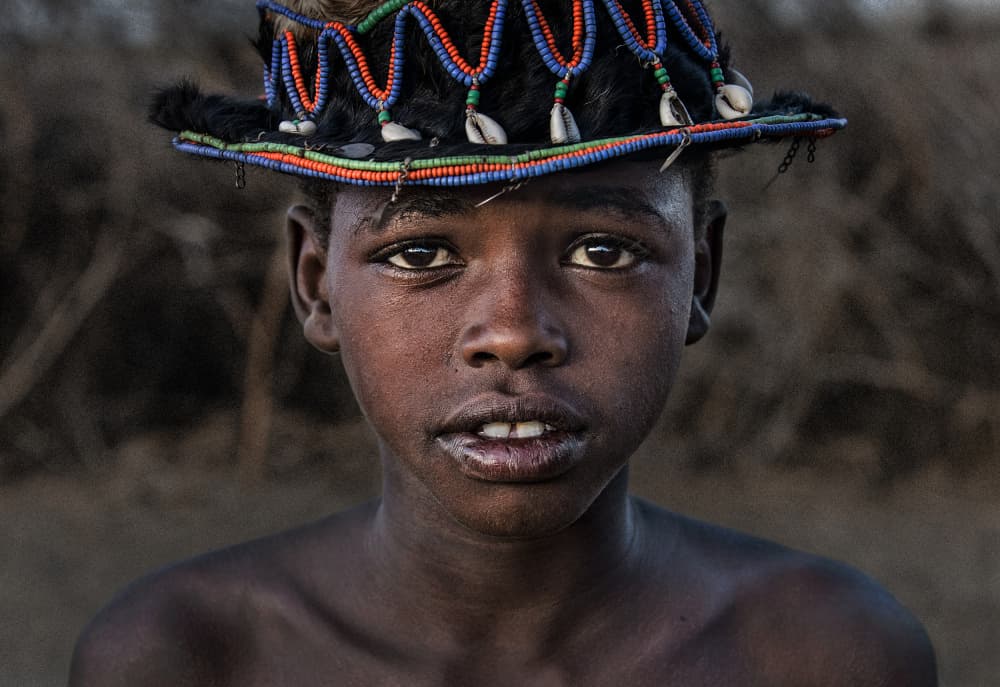 African Boy Beaded Hat by Joxe Inazio Kuesta Garmendia — canvas wall art