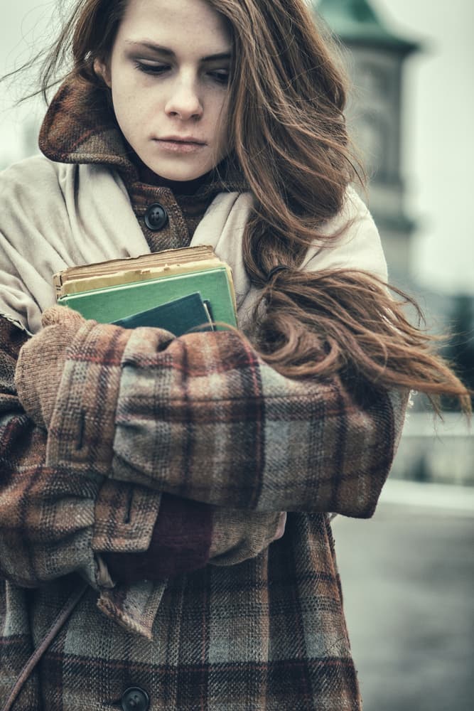 Pensive Girl With Books by Magdalena Russocka — canvas wall art