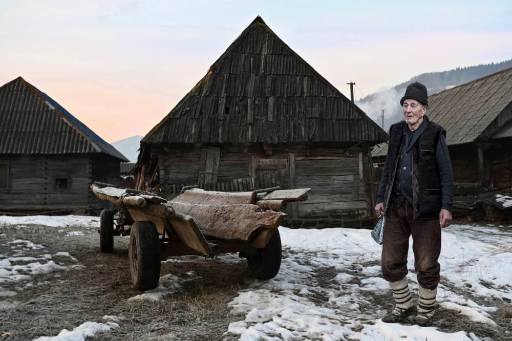 Elderly Man Winter Village by Irene Perovich — canvas wall art