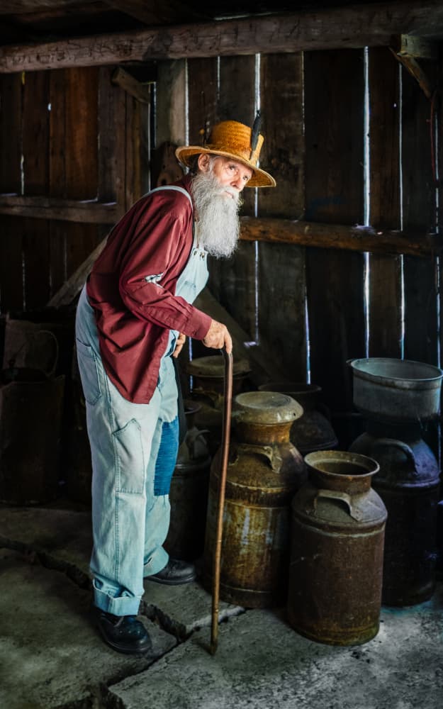 Old Farmer In Barn by Miroslaw Prybinski — canvas wall art