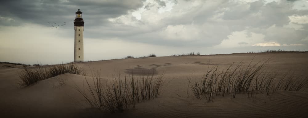 Moody Coastal Lighthouse by Wim Schuurmans — canvas wall art