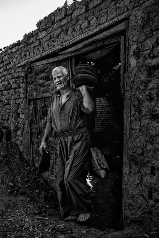 Old Man Carrying Pots by hishamtwhed — canvas wall art