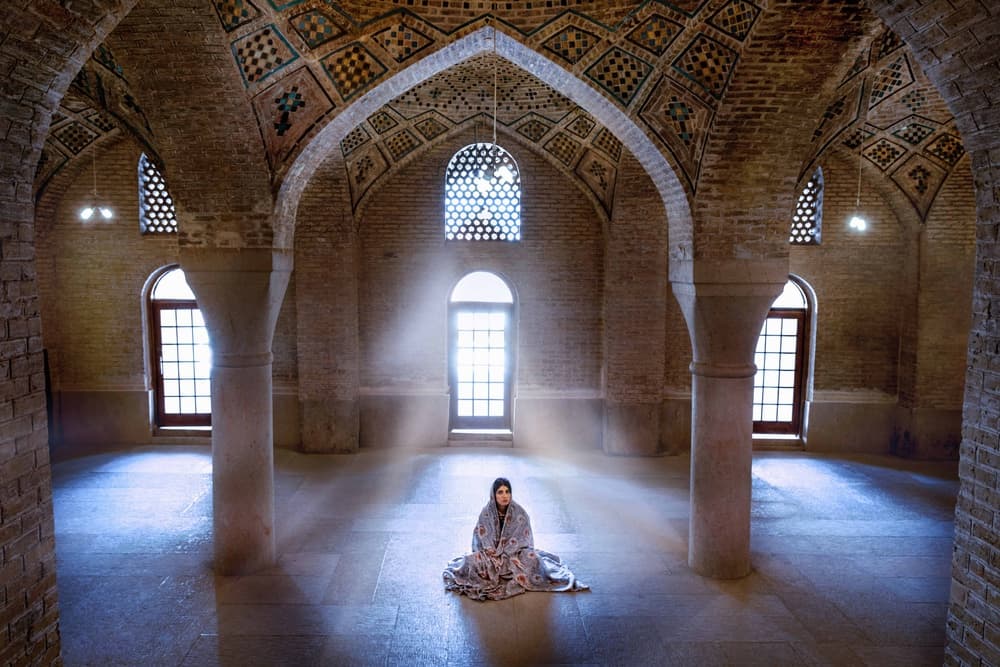 Woman In Sunlit Mosque by Saeed Zamani — canvas wall art