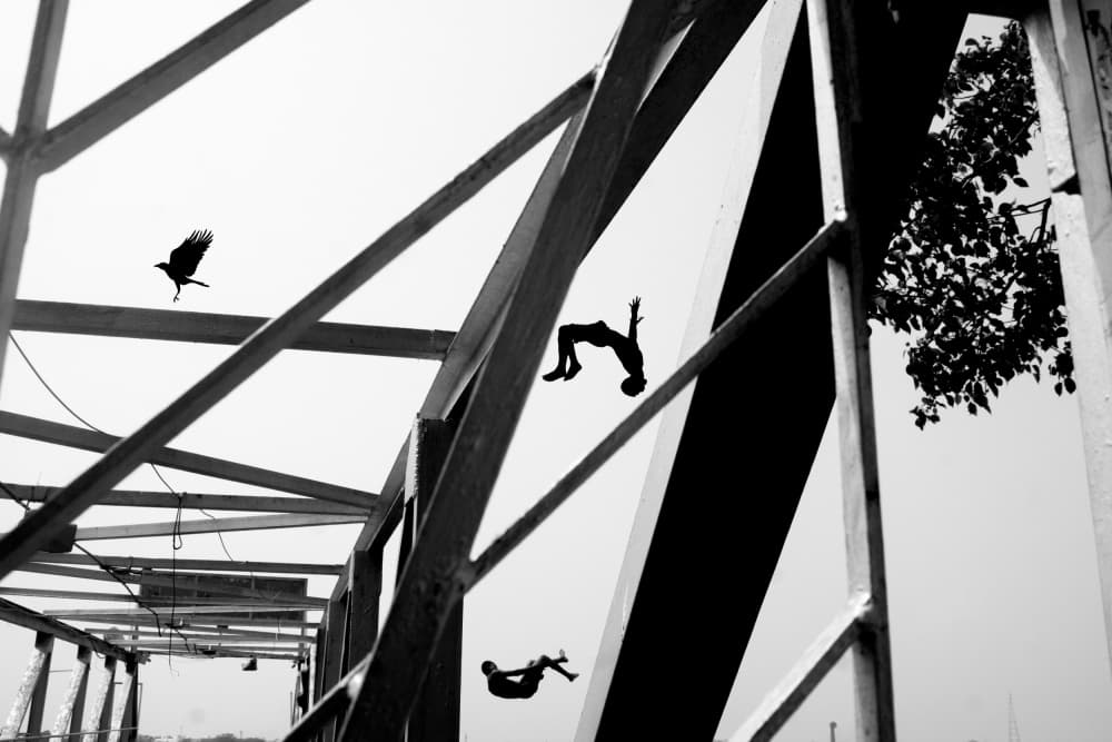 Boys Flipping Under Bridge by Ananway Ganguly — canvas wall art