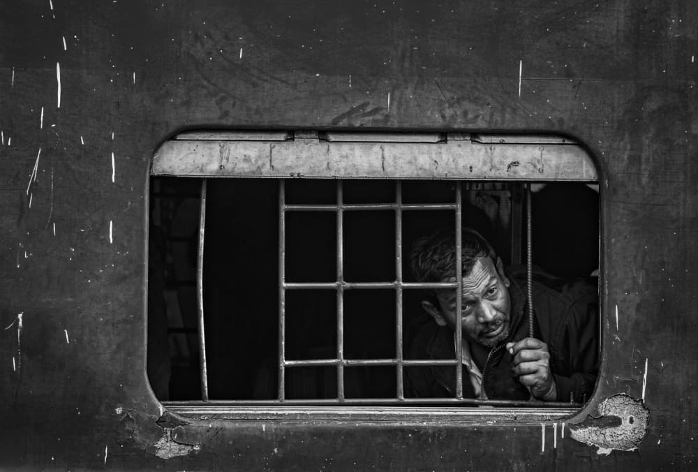 Man at Train Window by Avijit Sheel — canvas wall art