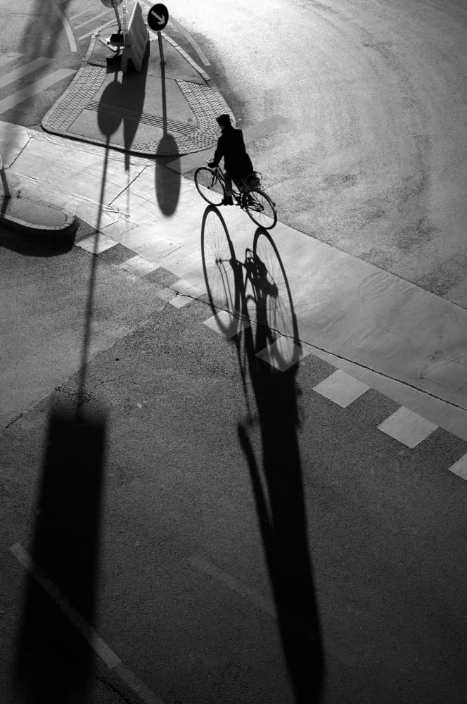City Cyclist Shadows by Tamas Dragon — canvas wall art